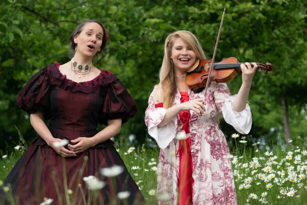 April and Grace playing the violin and singing